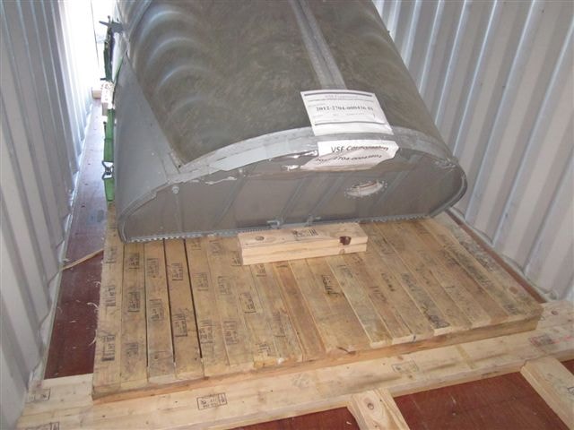 Crew module wrapped and secured to a custom timber base inside its shipping container