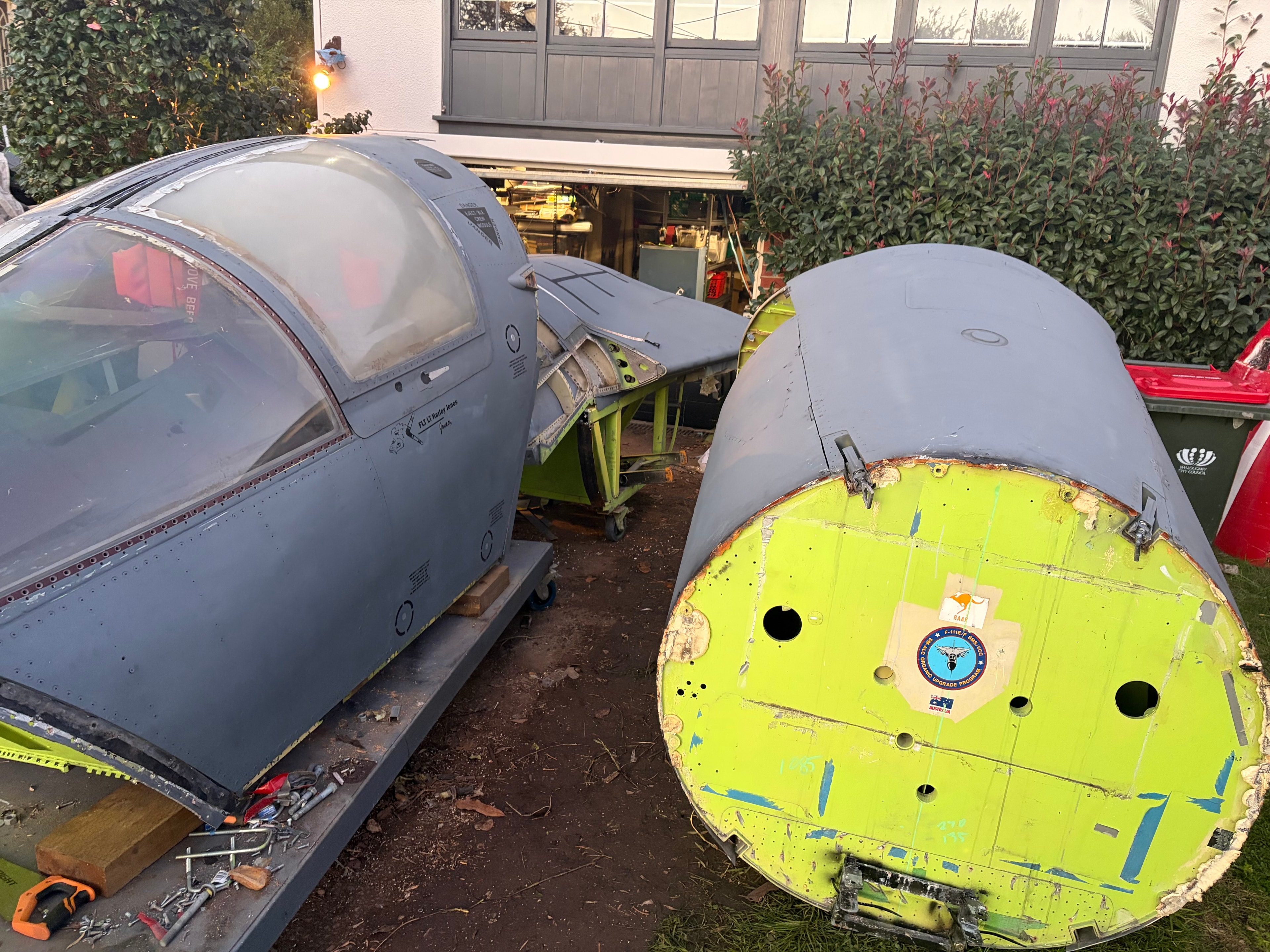 F-111 crew module and fuselage sections laid out in the yard, Sydney