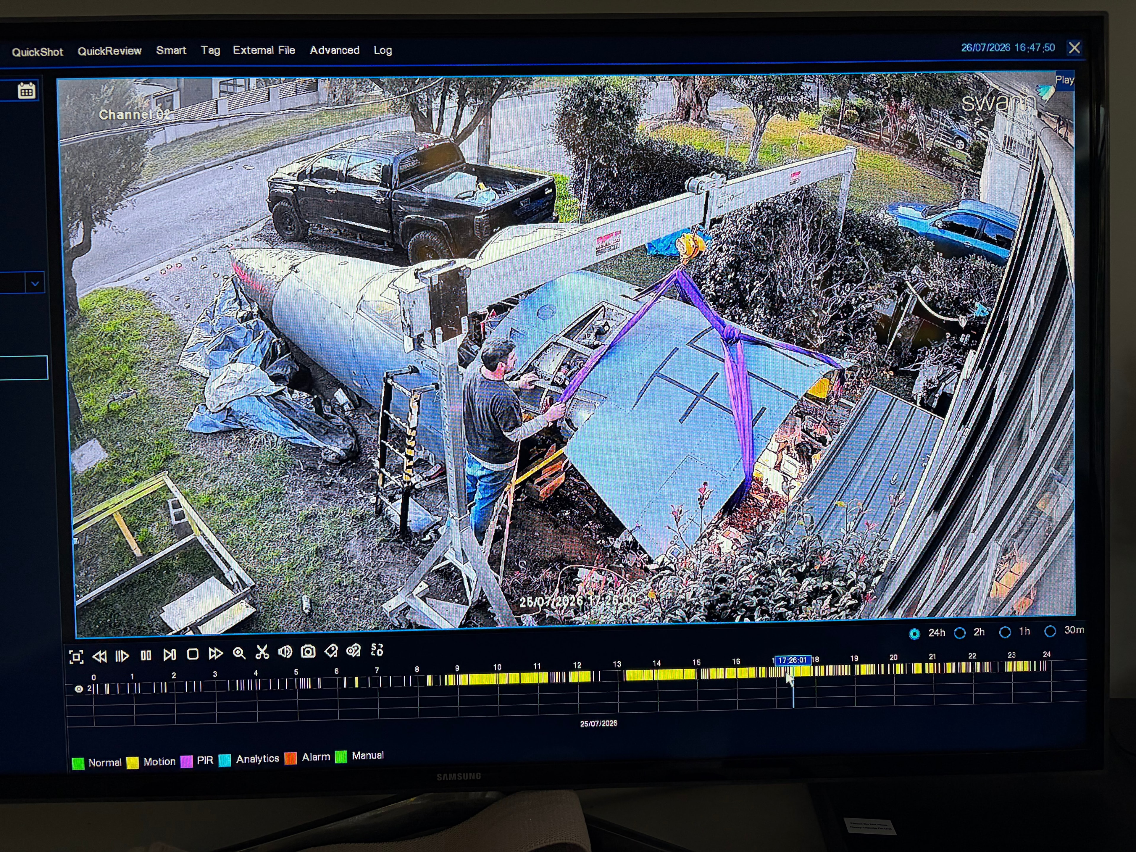 CCTV overhead view — crew module being lifted with purple straps, 25 July 2026 17:26